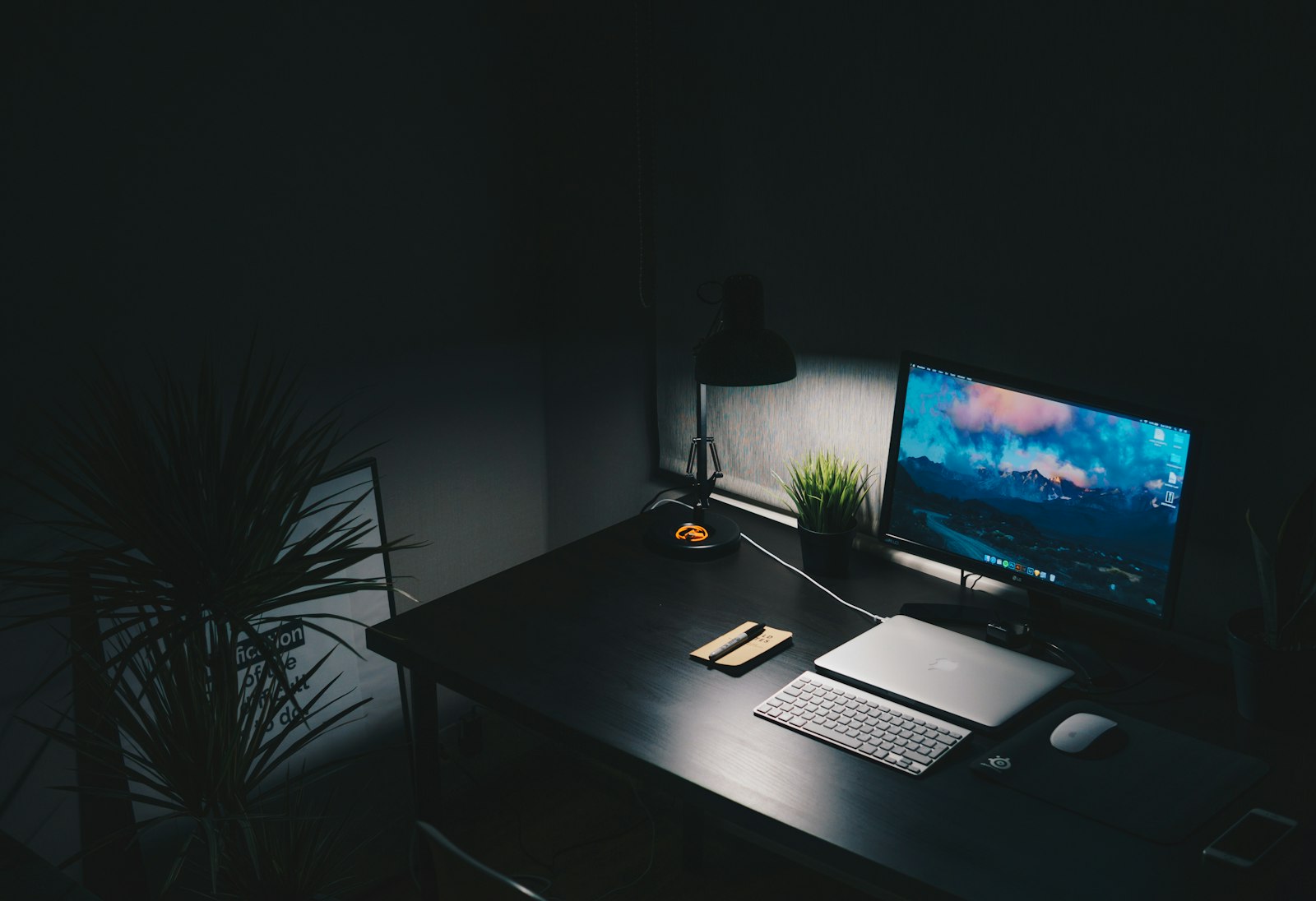 A workstation glowing in a dark room